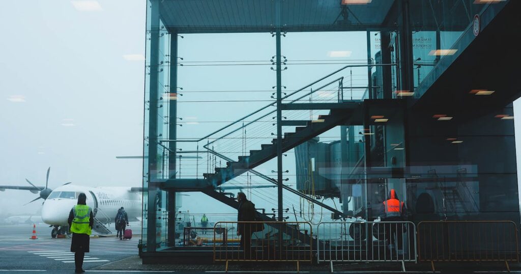 Travelers boarding an airplane at a European airport terminal