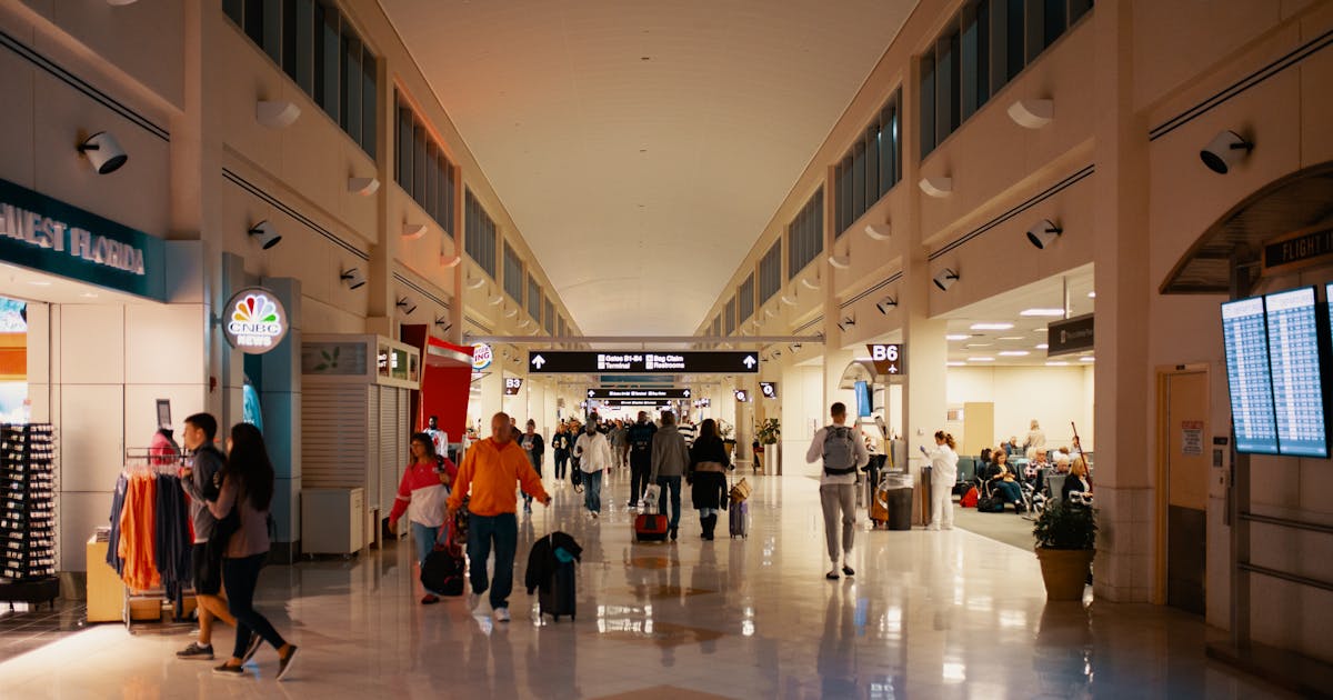 Airport terminal with travelers checking passport and visa requirements for European countries