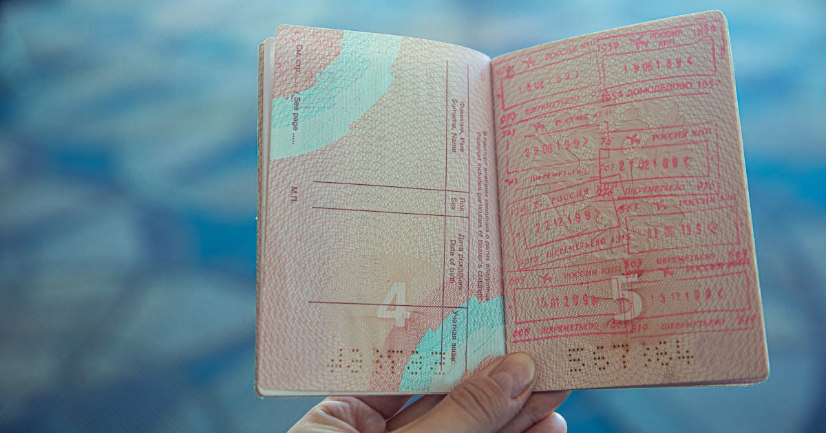 Open passport with international travel stamps for European border control