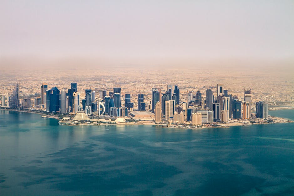 Stunning aerial view of the Doha skyline under a clear sky, showcasing modern architecture in Qatar.