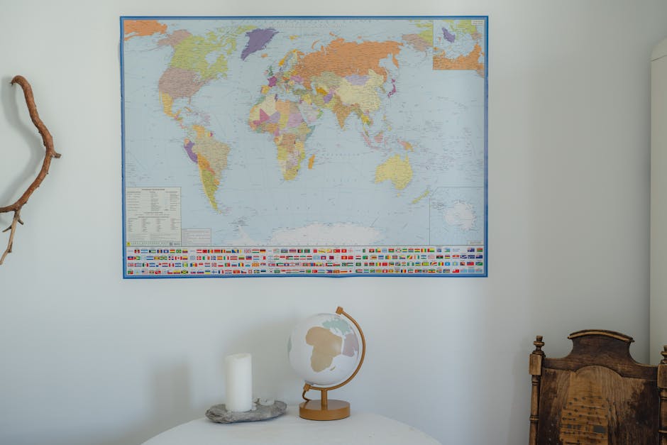 An indoor scene featuring a detailed world map and globe on a rustic table.