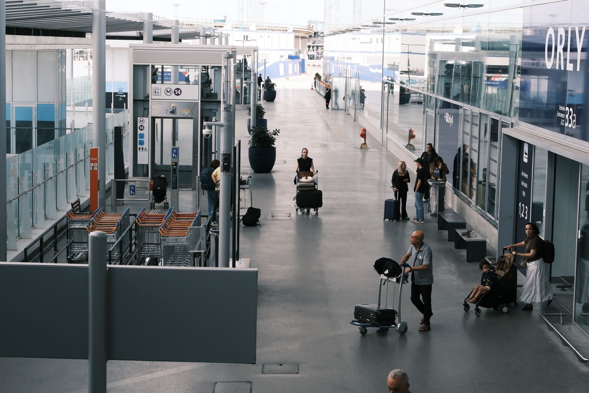 family with children at European airport, smiling, luggage visible