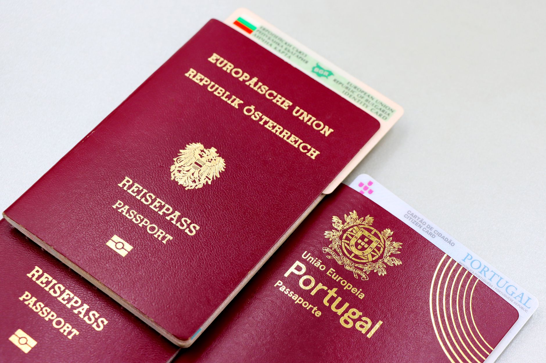 UK passport next to EU travel documents and map of Europe