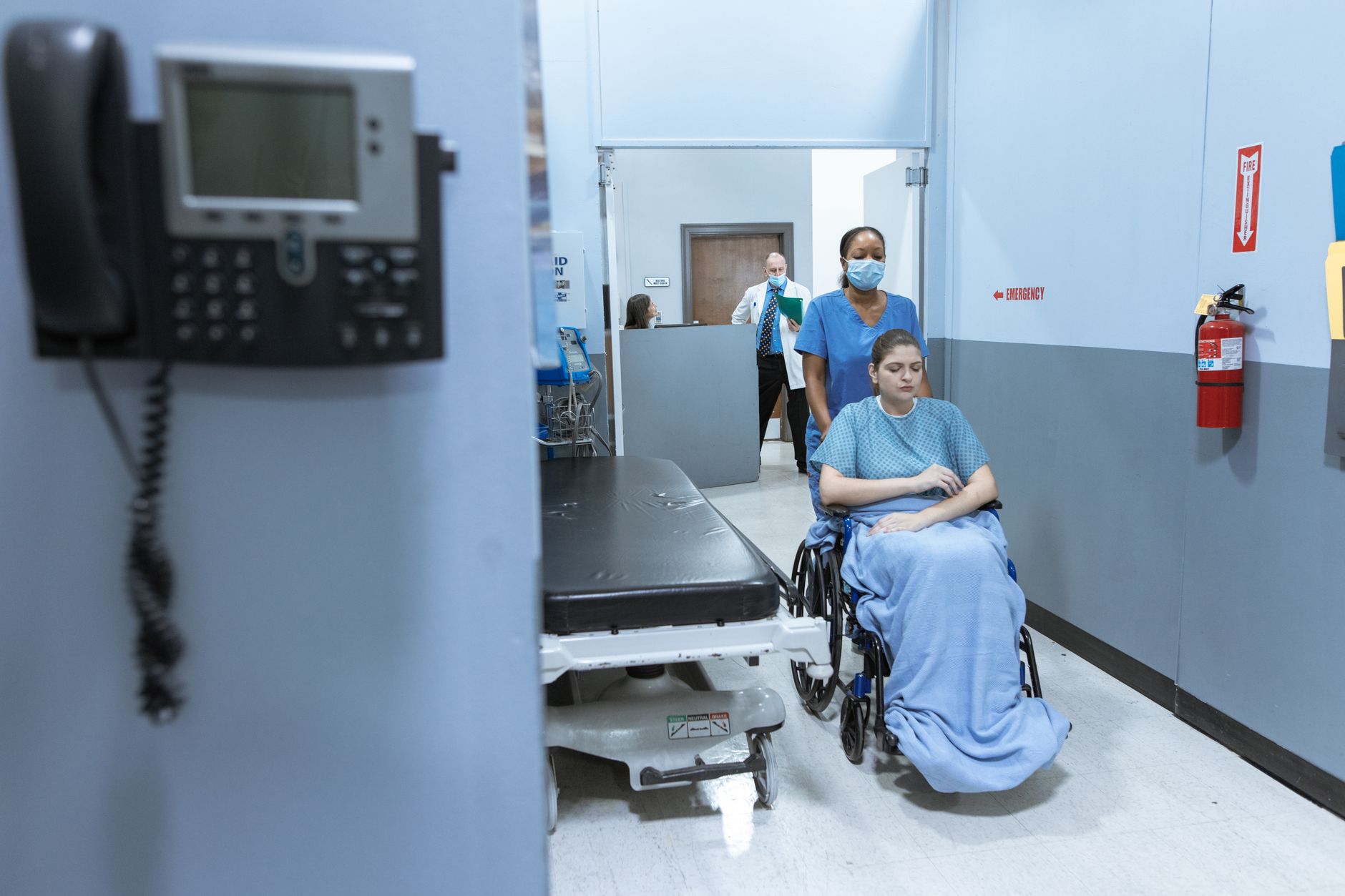 traveller receiving medical treatment at European hospital, insurance card visible