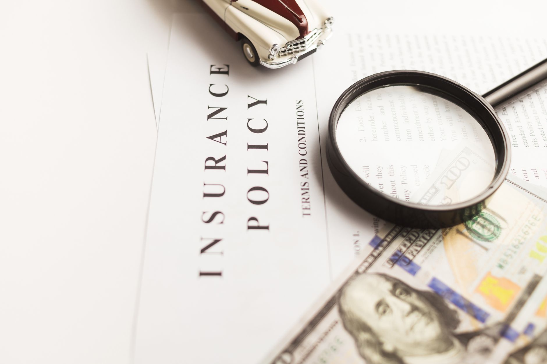 insurance policy document, calculator and stethoscope on table