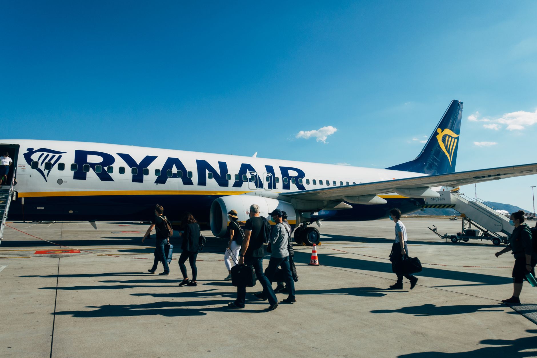 traveller confidently boarding plane at European airport, insurance documents in hand