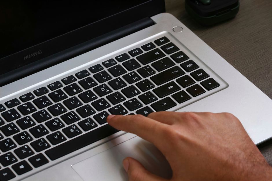 Person typing travel details into a laptop