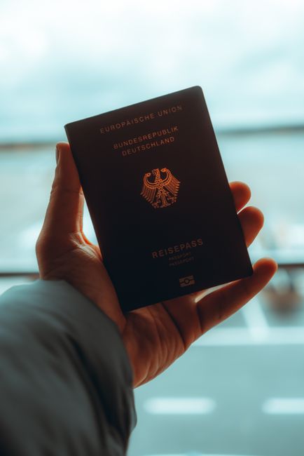 Family checking travel documents at an airport