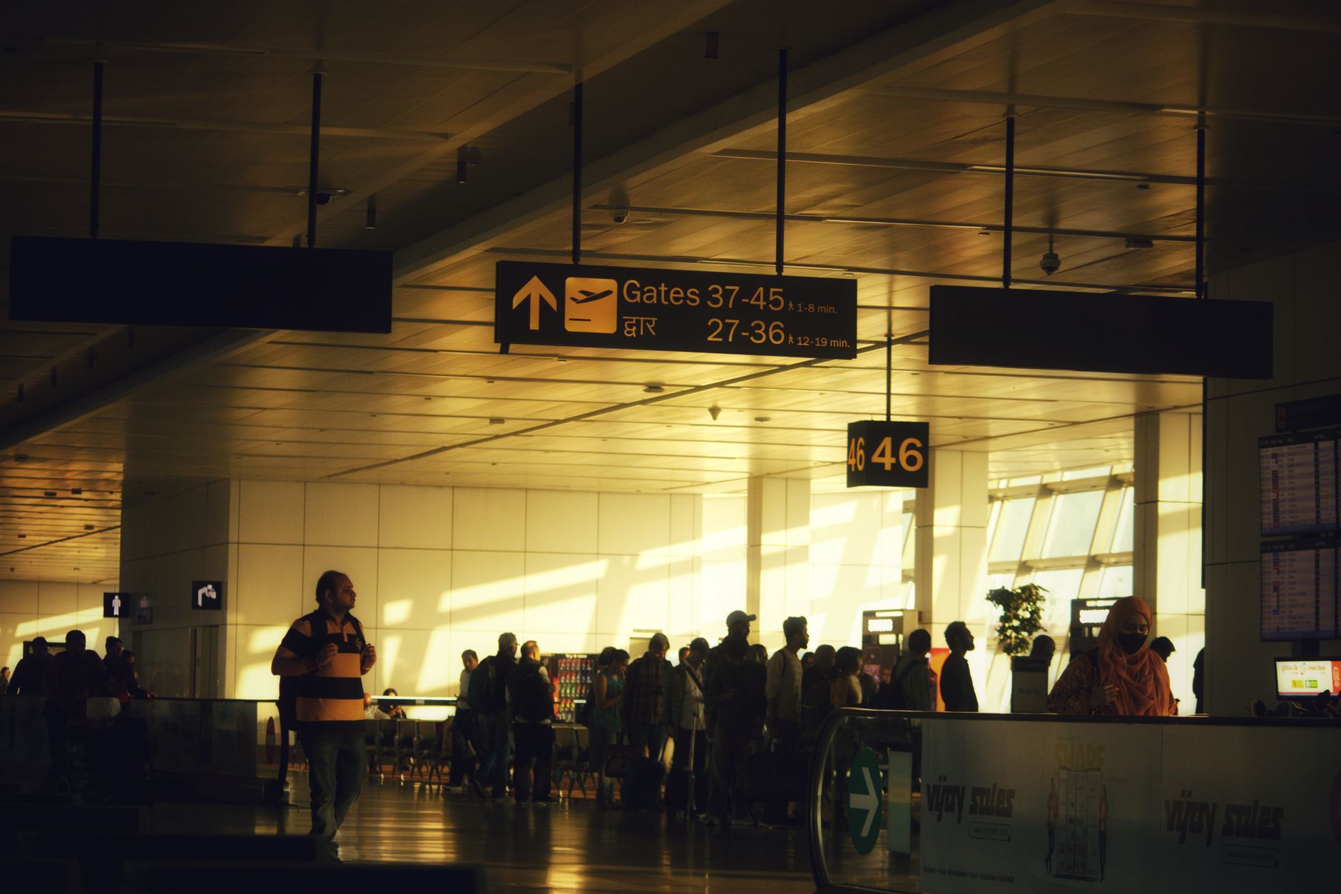 Travellers queuing at an airport departure gate where exit records are captured