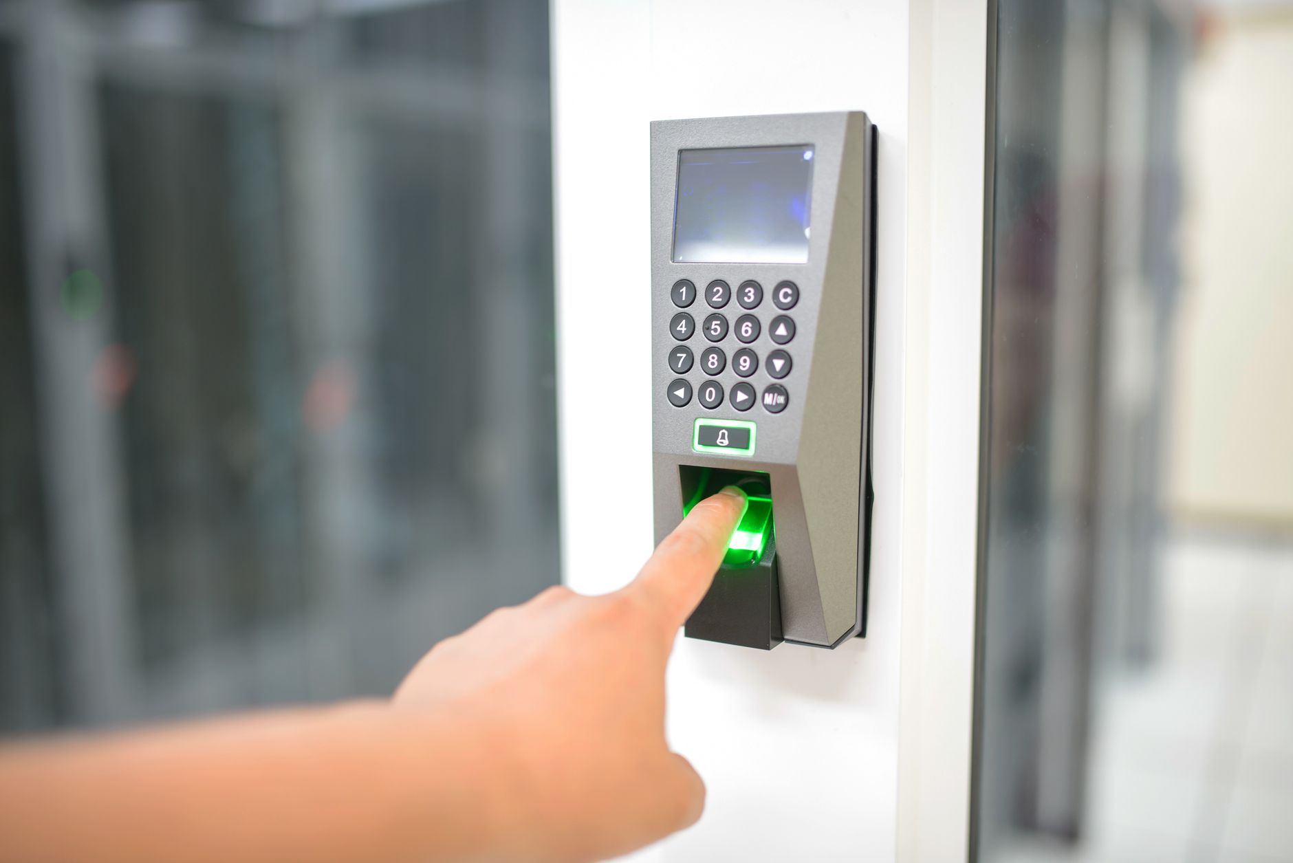 Close-up of a fingerprint scanner reading four fingers during airport biometric check