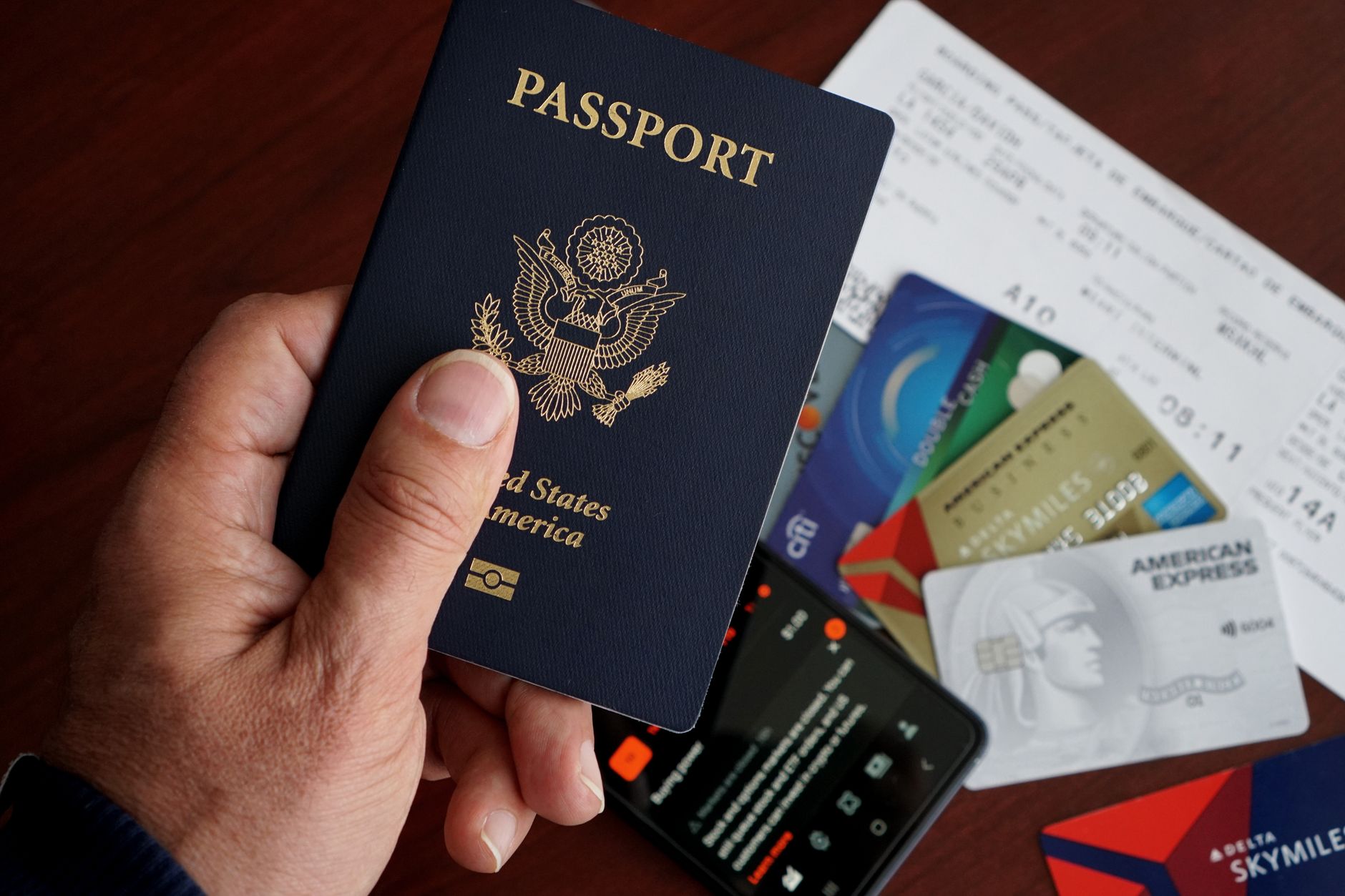 Border control officer examining a passport at a checkpoint booth on arrival