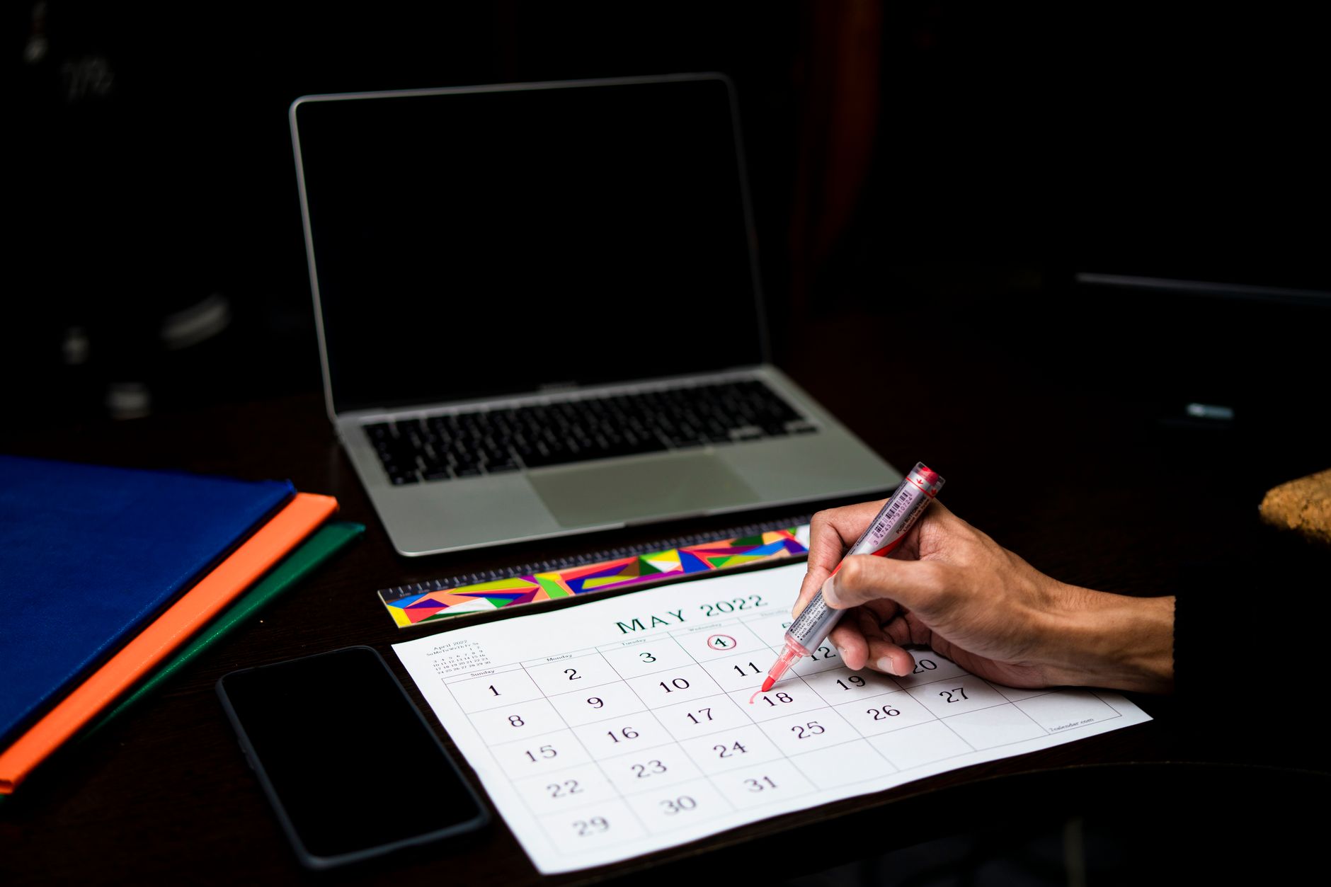 Traveller marking trip dates on a calendar while planning a European journey