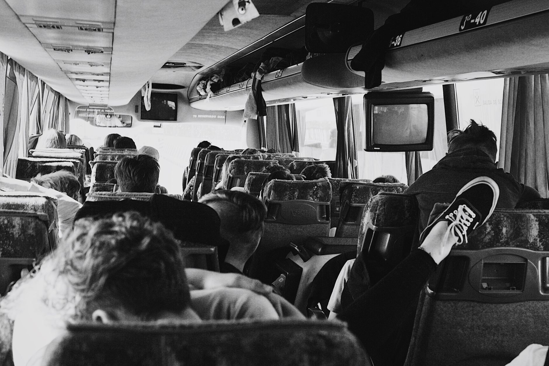 Group of coach passengers with luggage boarding a travel bus