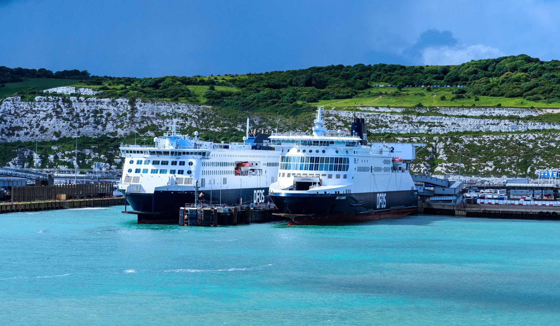 Ferries at the Port of Dover with the English coastline and harbour behind