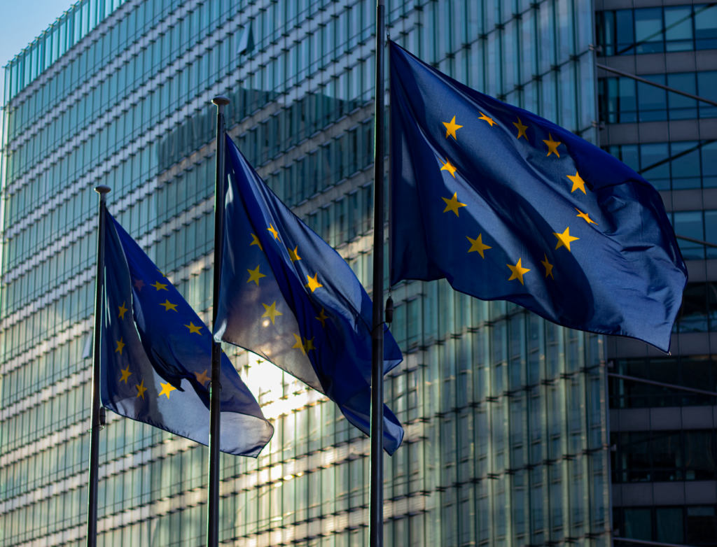 European Union flags flying outside an official EU institution building in Brussels