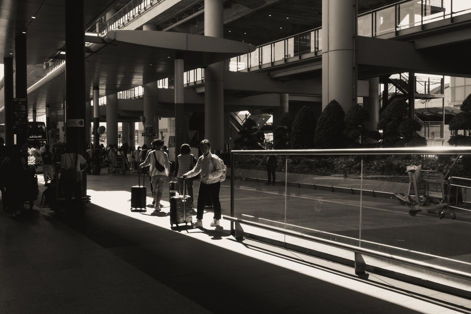 Non-EU traveller with luggage on an airport layover in a European transit hall