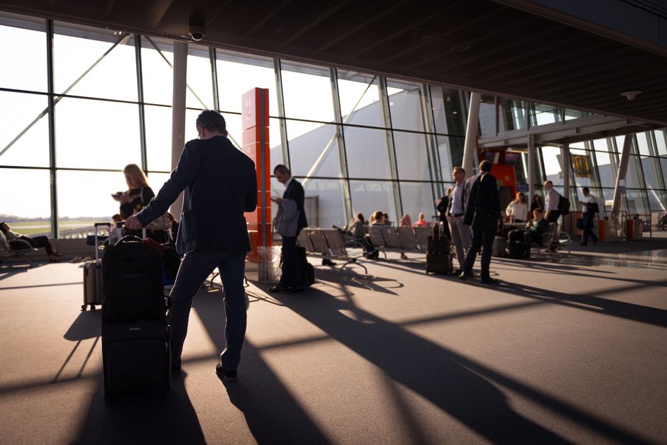 Traveller checking a boarding pass and passport before an airport layover connection