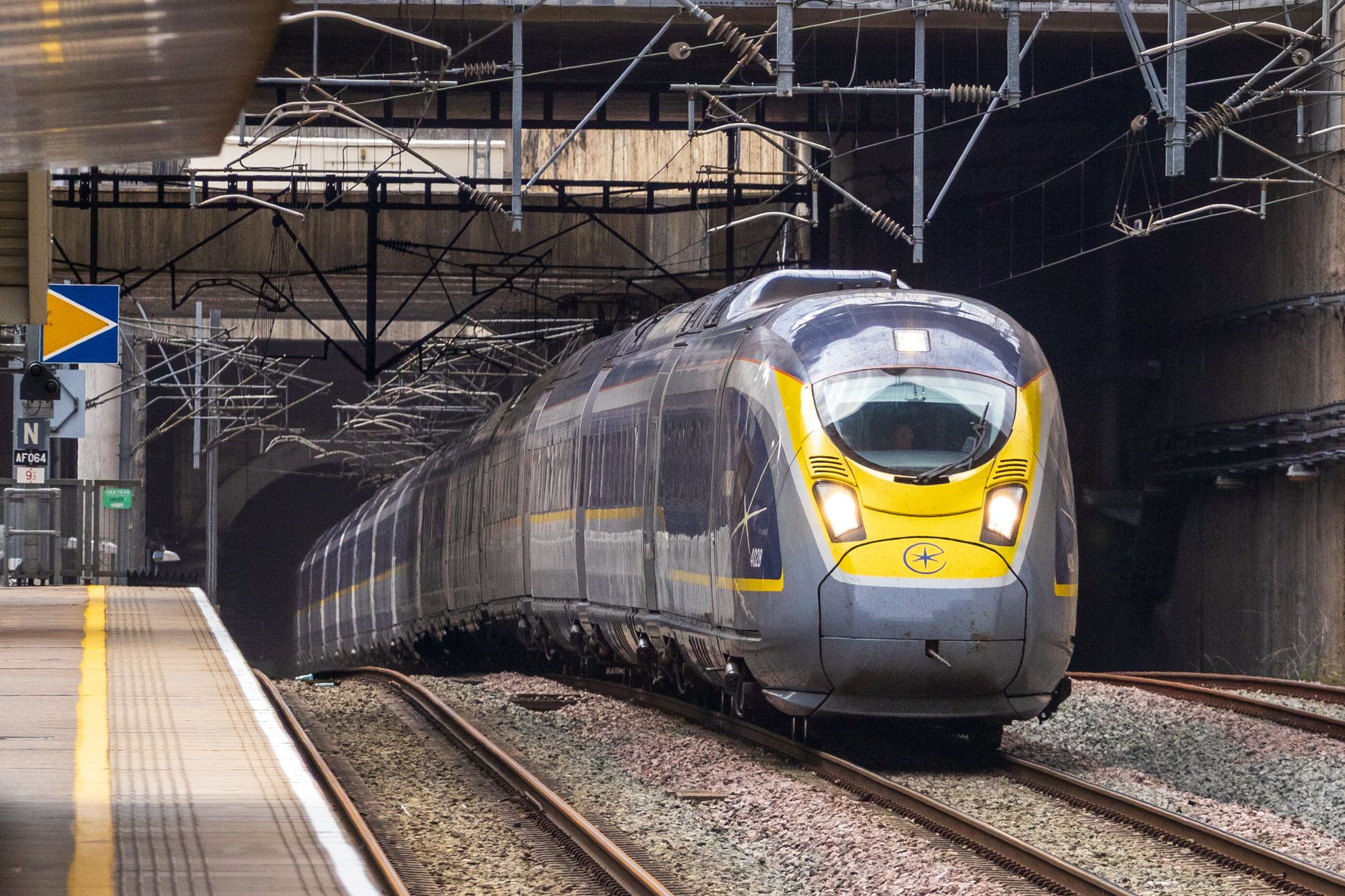 Eurostar train waiting at a London station platform with departure boards