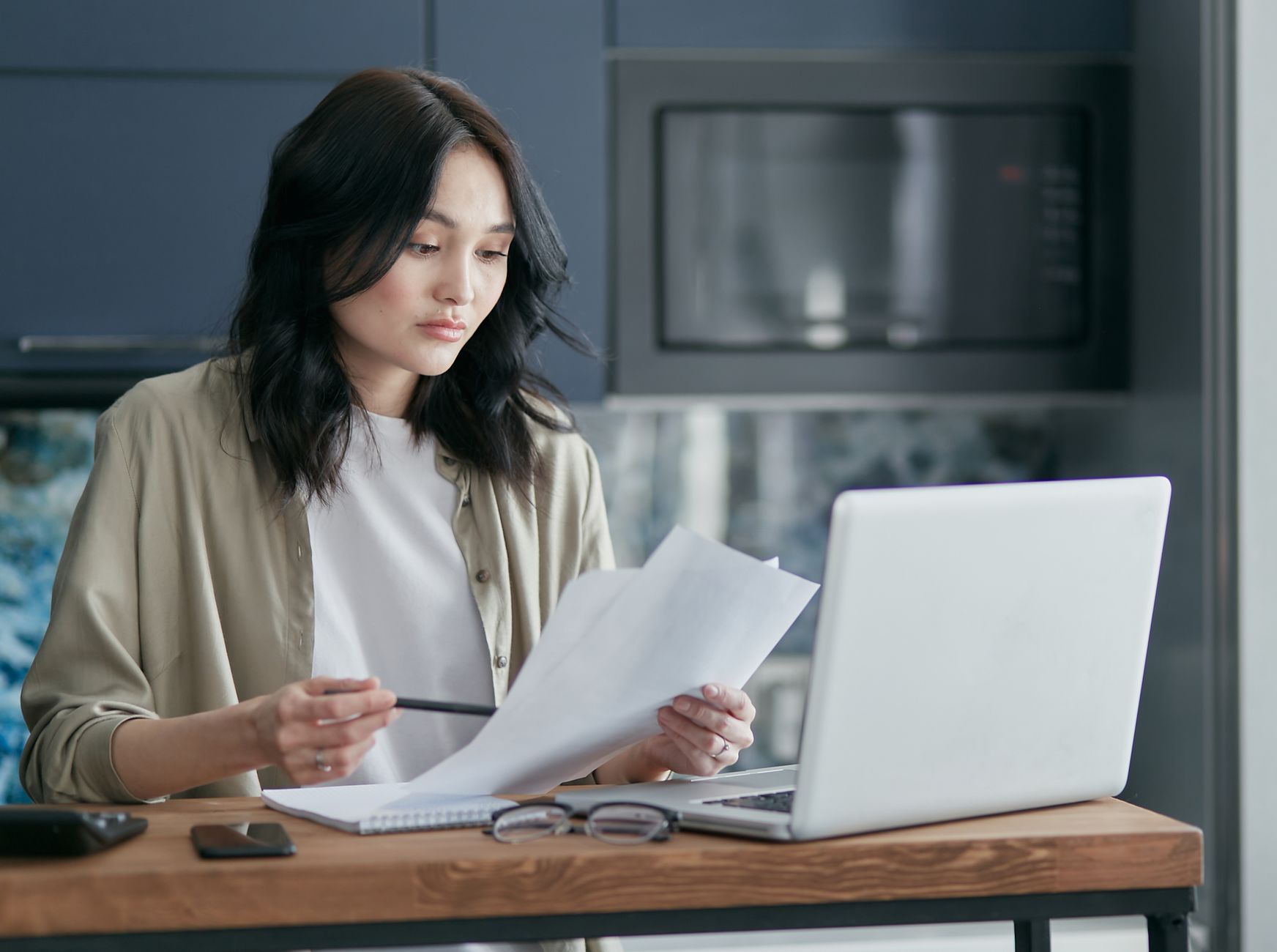 Person reviewing a printed document beside a laptop while checking personal data rights