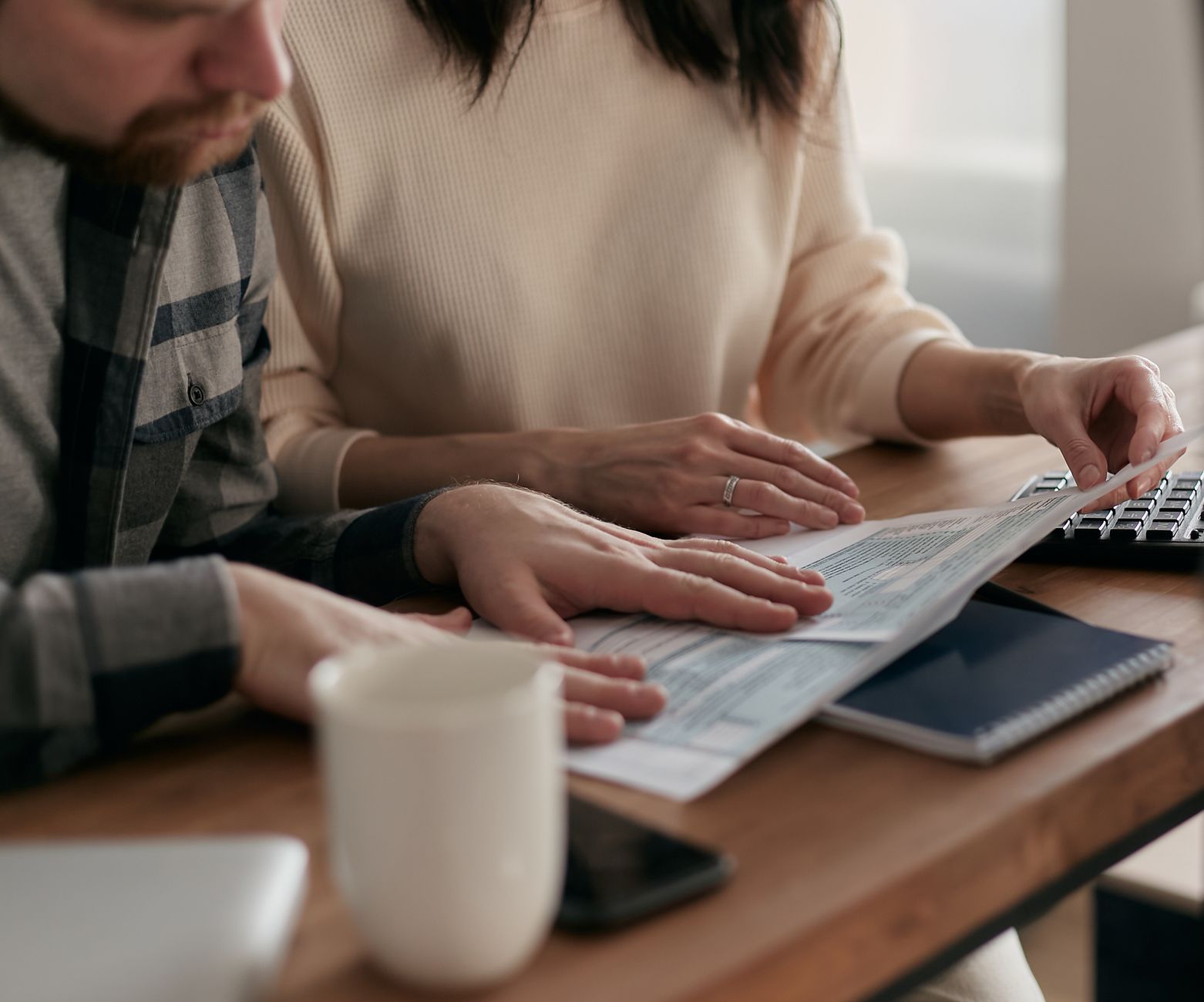 Family reviewing passport details together before submitting an ETIAS application
