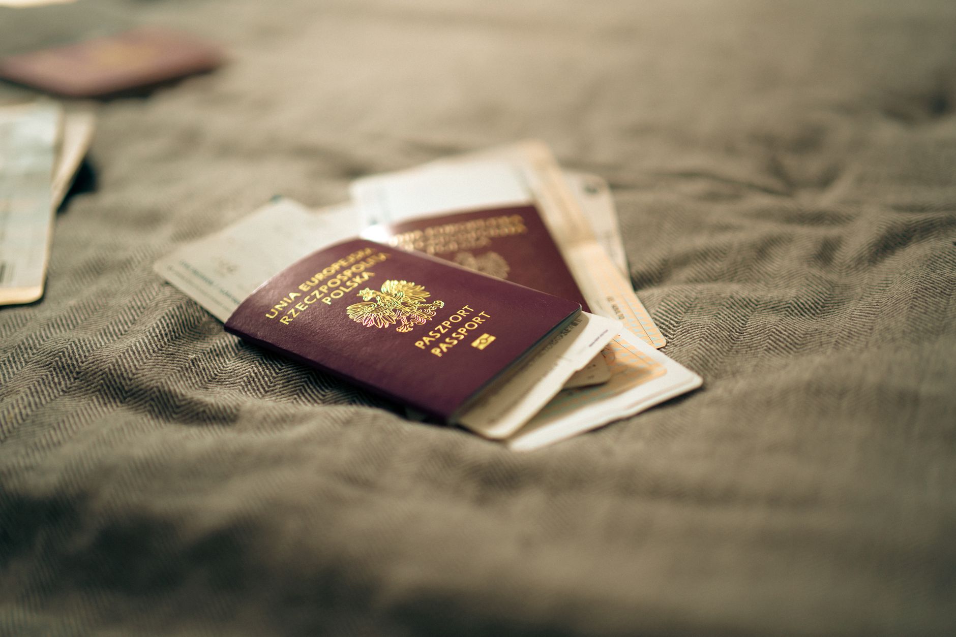 Passport and documents at a Schengen border control desk where ETIAS is checked during a European layover