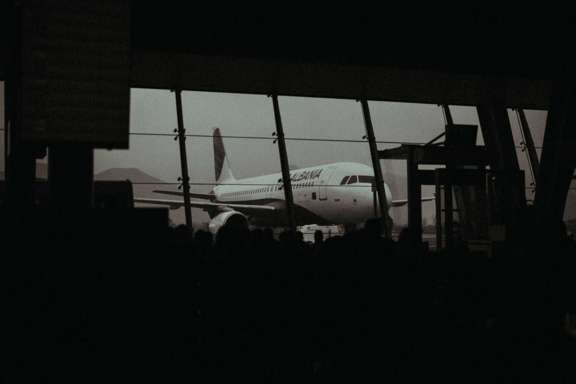 Passengers waiting at a gate after a missed connecting flight, a scenario where ETIAS for a layover suddenly matters
